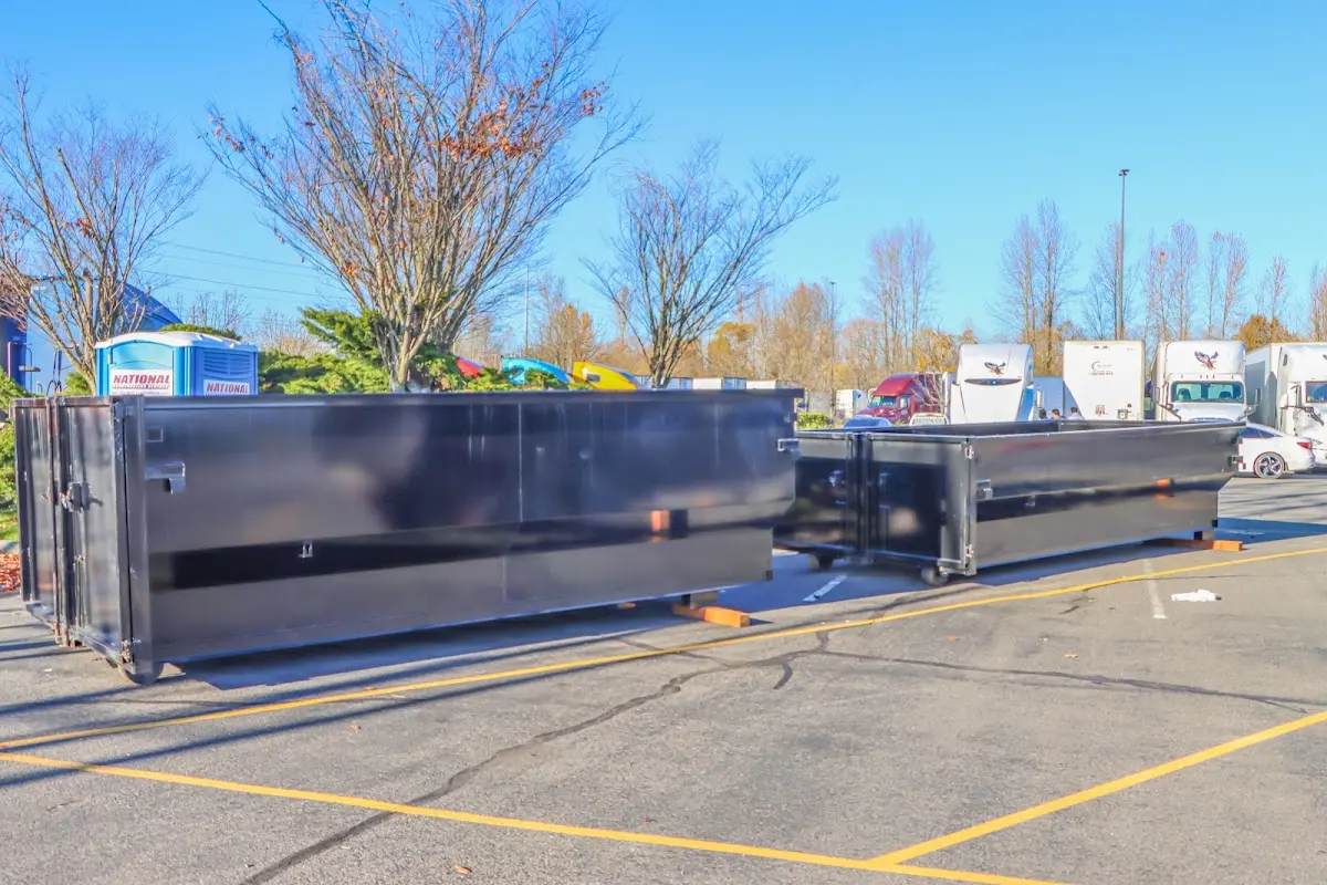 Professional dumpster rental service with roll-off container on residential driveway in Whitefish Bay
